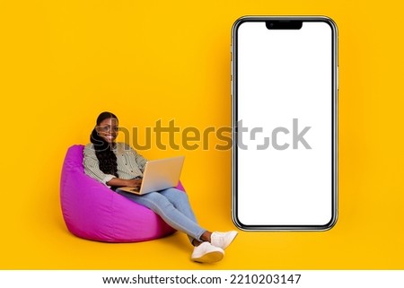 Full length photo of hr millennial lady write laptop near advert wear glasses blouse jeans footwear isolated on yellow background