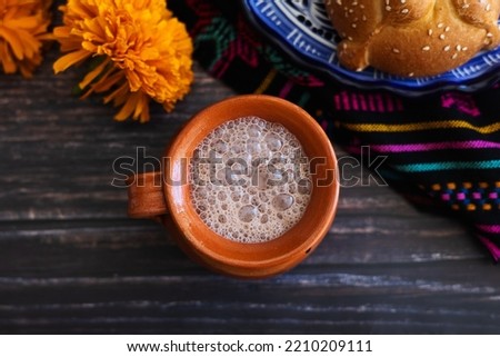 clay cup of Mexican hot chocolate on table in Mexico 