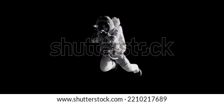 Caucasian female astronaut using her mobile phone during spacewalk, messaging, taking pictures Royalty-Free Stock Photo #2210217689