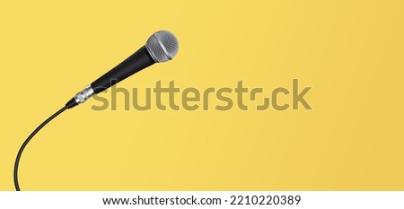 Microphone with cable banner on yellow background