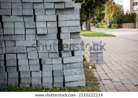 Gray cobblestones in a pile. Pedestrian sidewalk repair.