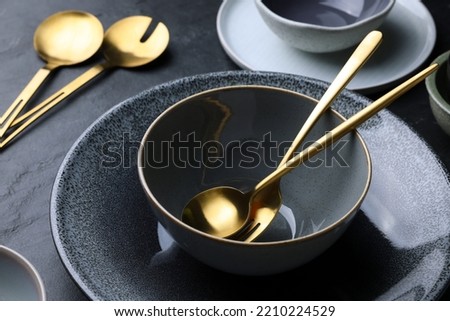 Set of clean tableware on black table, closeup Royalty-Free Stock Photo #2210224529