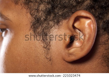 close up shot of the ear of a dark-skinned young man Royalty-Free Stock Photo #221023474
