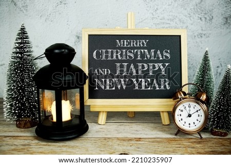 Merry Christmas and Happy New Year text message with alarm clock, LED candle light and Christmas pine tree