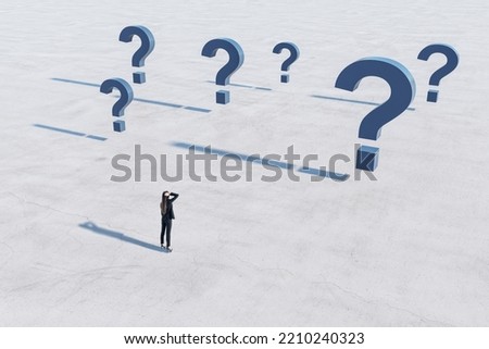 Find solution and right decision concept with confused businesswoman on empty concrete field in front of blue question marks