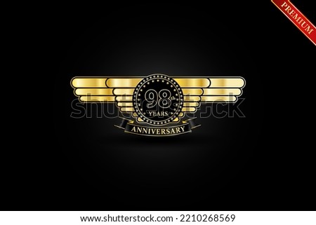 98th anniversary golden wing gold logo with gold ring and ribbon isolated on black background, vector design for celebration.