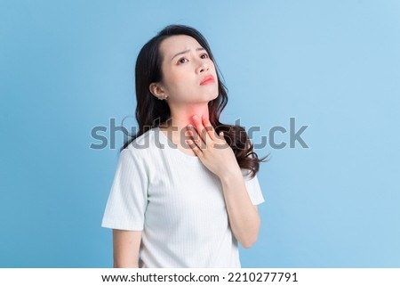 Young Asian woman has a sore throat
 Royalty-Free Stock Photo #2210277791
