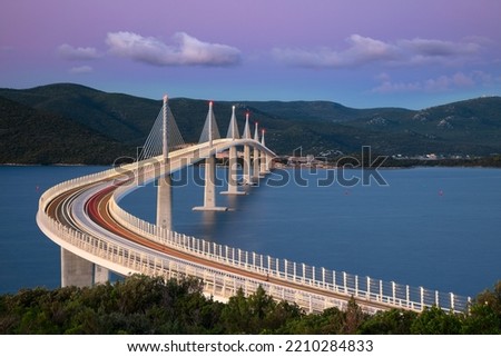 Peljesac Bridge, Croatia. Image of beautiful modern multi-span cable-stayed Peljesac Bridge over the sea in Dubrovnik-Neretva County, Croatia at sunrise. Royalty-Free Stock Photo #2210284833