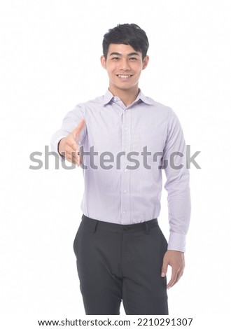 young businessman in striped shirt with welcome gesture  
standing posing in studio
