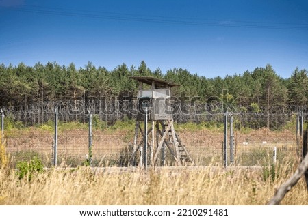 Border between Serbia and Hungary bewtween Kelebia and Tompa, with a watchtower and the Hungarian border fence. Royalty-Free Stock Photo #2210291481