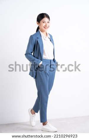 Full length photo of young Asian business woman on background