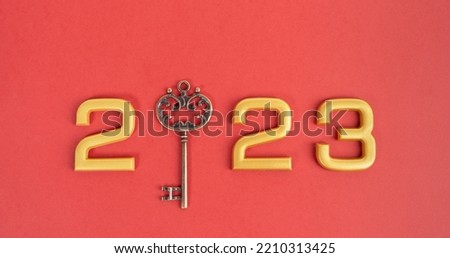 Number 2023 with key on red background. Happy New Year and Christmas 2023 concept. 