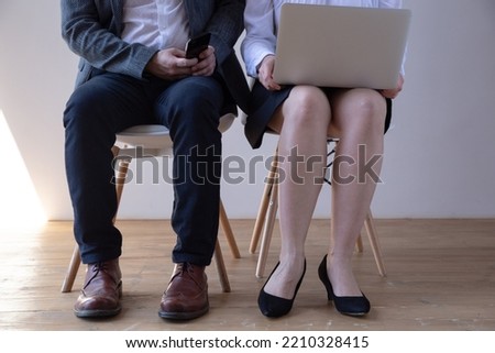 businesspeople sitting in queue and waiting for interview in office, business concept
