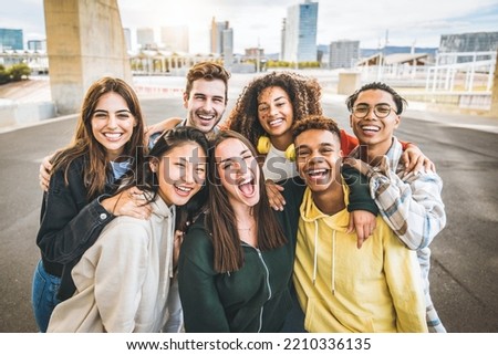 Multiracial group of friends taking selfie picture outdoors - Millennial people having fun on city street - International students smiling together at camera - Youth culture and community concept Royalty-Free Stock Photo #2210336135