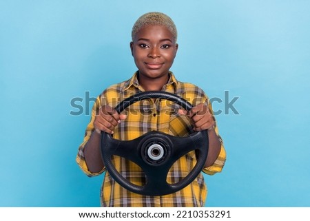 Photo of pretty charming lady wear checkered shirt smiling driving auto isolated blue color background