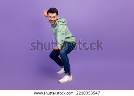 Full length photo of young hipster man wear nice outfit khaki hoodie denim positive calm smiling posing looking you isolated on bright violet color background