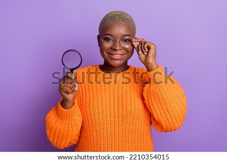 Photo of smart young woman searching opportunity dressed stylish fall orange knitted sweater eyeglasses isolated on violet color backgroun