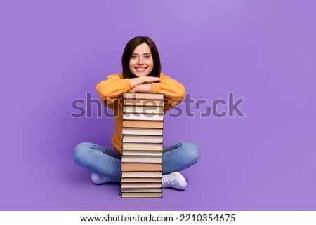 Full length photo of attractive nice smart intellectual woman sitting chill vacation pile books empty space new ad library isolated on purple color background