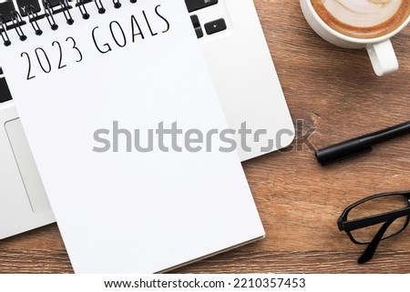 Notebook with 2023 goals text on it to apply new year resolutions and plan. Royalty-Free Stock Photo #2210357453