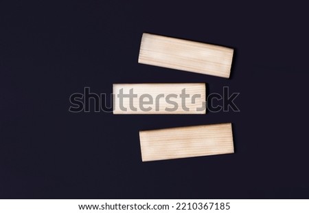 Three wooden blocks with space to insert text on a black background. copy space