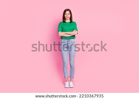 Full body photo of cute young lady stand crossed arms serious professional wear stylish green outfit isolated on pink color background