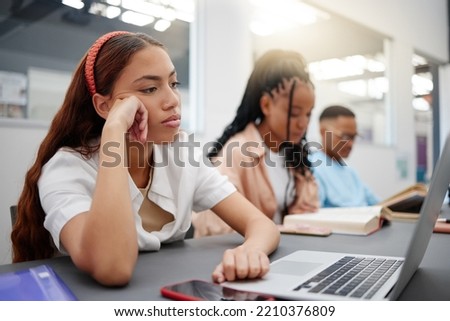 Mental health, studying and student with depression reading course information on laptop in library or university classroom. Sad, depressed and burnout college woman with exam problem or fail results Royalty-Free Stock Photo #2210376809