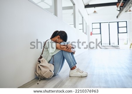 Sad, depression and mental health issue of a woman university student on a floor. Fear, anxiety and study stress of a female from India feeling depressed and overwhelmed from a study fail at home Royalty-Free Stock Photo #2210376963