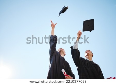 Graduation cap throw, blue sky and friends after a diploma, certificate and degree ceremony event. Education, university and school scholarship success of students happy about college achievement Royalty-Free Stock Photo #2210377089