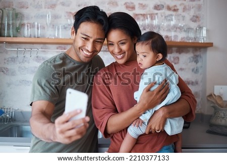 Happy, parents and baby with down syndrome taking selfie together in kitchen of family home. Happiness, smile and mother and father bonding with disabled child while taking picture on phone in house.