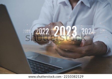 Trend of 2023. people business investor using mobile phone with virtual 2023 year diagram, business trend, change from 2022 to 2023, strategy, investment, business planning and happy new year concept Royalty-Free Stock Photo #2210382129
