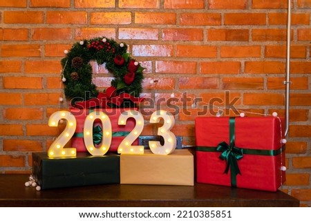 2023 New Year celebration sign in dinner party with present gifts on Merry Christmas Eve Xmas on holiday at home. Lifestyle
