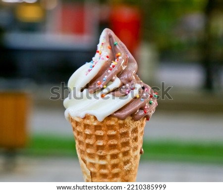 
ice cream in a waffle cup on a blurred background, sprinkled with spices