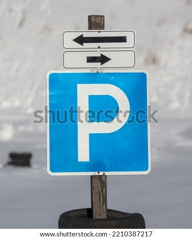 Road sign parking on the road in winter