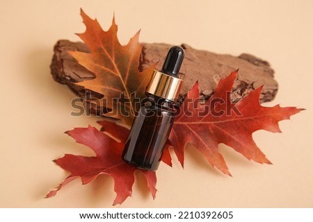 Set of wooden podiums, decor and autumn leaves against beige background. Fall Seasonal Background Royalty-Free Stock Photo #2210392605