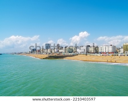 Brighton Beach and coastline in summer with blue sky and turquoise sea.