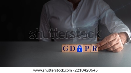 man posing wooden block g d p h or general data protection regulation . concept of internet security . Royalty-Free Stock Photo #2210420645