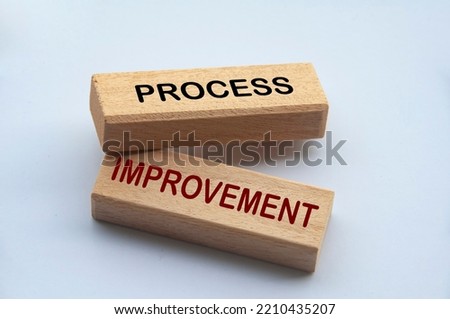 Process improvement text on wooden blocks with white cover background. Process improvement and business concept.