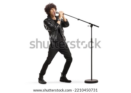 Rock singer in a leather jacket singing loud on a microphone isolated on white background