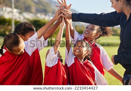 High five, team and girls soccer celebrate a victory and win on field with coach. Sports. young and female children smile, relax and happy they won soccer match with training, teamwork and together.