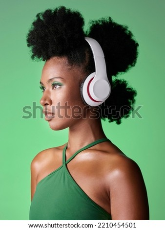 Black woman with headphones listening to music or podcast on green studio background mockup advertising and marketing. African gen z girl with audio for youth lifestyle or streaming service mock up