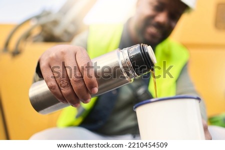 Black man and construction worker on lunch for coffee or tea in cup on site, doing cargo and shipping. Male contractor, smile and guy use mug for hot beverage in flask and helmet for logistics work. Royalty-Free Stock Photo #2210454509