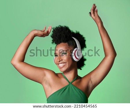 Green screen music, radio dance and black woman with smile while streaming podcast against a mockup studio background. Happy and smile African person with dancing energy from audio with headphones