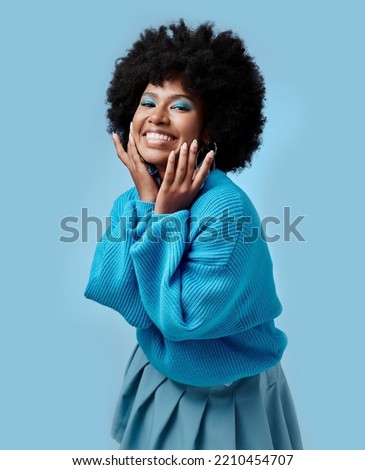 African beauty, makeup and portrait of a black woman with blue eyes shadow, face cosmetics and afro hair or good skin. Funk, smile and young happy girl with vintage, retro and creative fashion style.