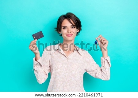 Photo of charming customer lady stylish outfit arm hold key plastic card new flat good choice ownership isolated on cyan color background