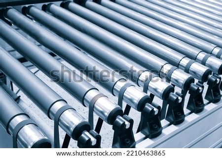 Crossing of the roller conveyor, Production line conveyor roller transportation objects Royalty-Free Stock Photo #2210463865