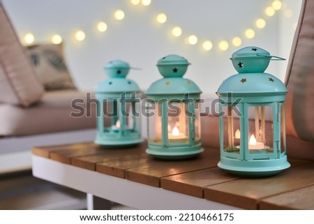 Three mint lamps at night on a table in a modern house balcony