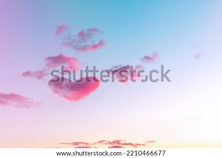 A large heart-shaped cloud in the sky after sunset.