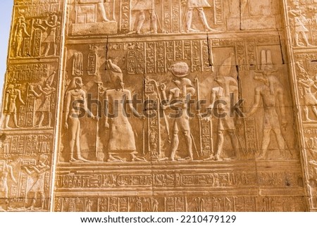 Kom Ombo, Aswan, Egypt. Carved mural featuring the crocodile god Sobek and falcon god Horus at the Kom Ombo temple. Royalty-Free Stock Photo #2210479129