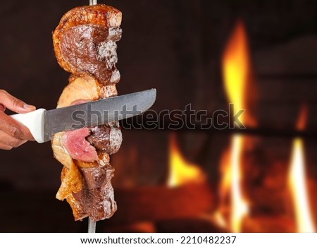 Steak rotisserie at the steakhouse, sliced picanha Royalty-Free Stock Photo #2210482237