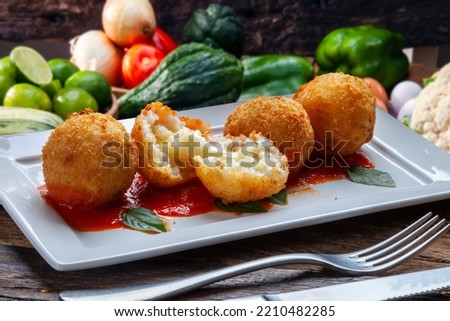Fried rice balls. Traditional from Brazil where it is called Bolinho de arroz. Royalty-Free Stock Photo #2210482285